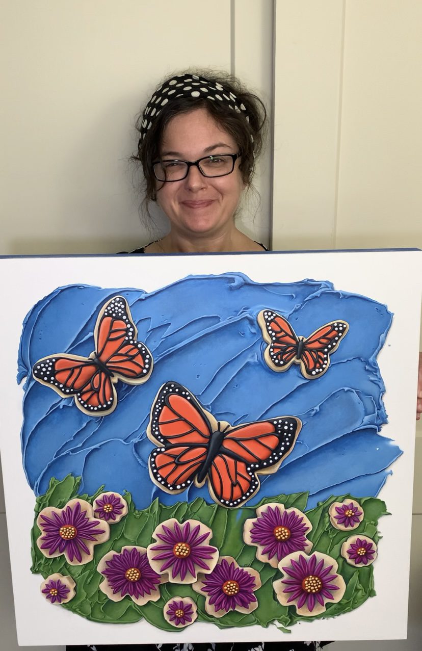 Acrylic realism painter Kim Testone with her painting Butterflies in the Sky