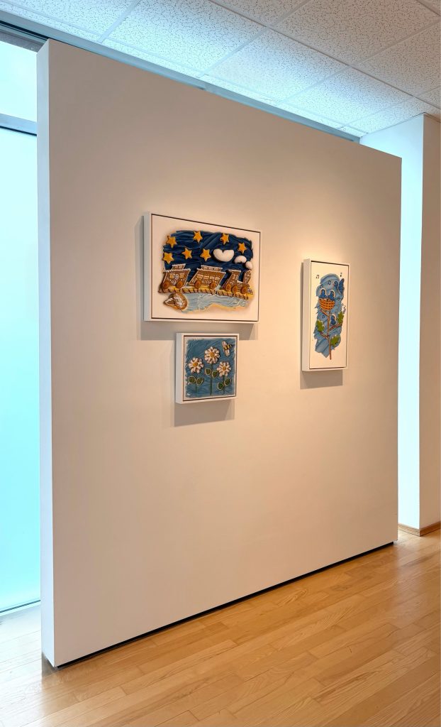 Three recent whimsical trompe l'oeil paintings by Kim Testone, hanging as part of the March 2026 exhibition at Hidell Brooks Gallery.