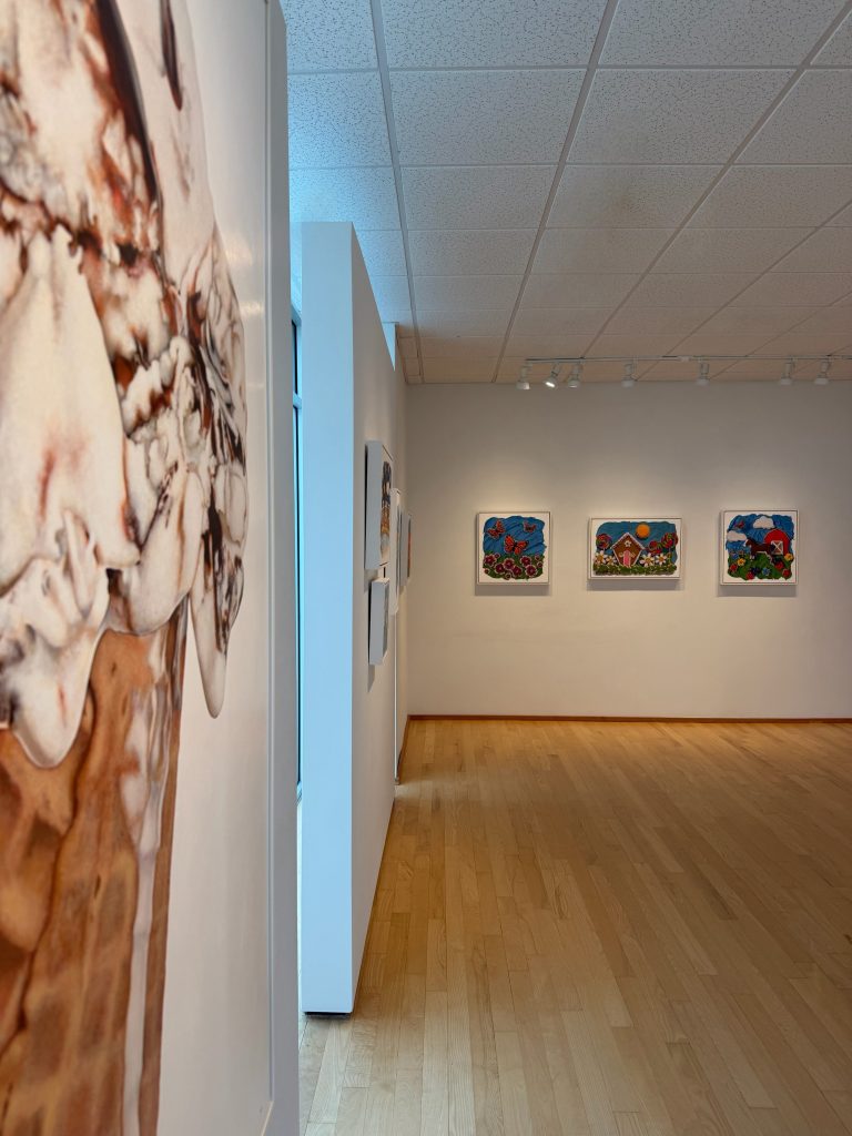 Left, the Giant Fudge Ripple painting by Kim Testone. In the distance, a few of her new whimsical trompe l'oeil paintings.